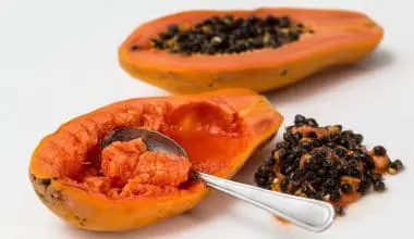 a cut papaya with a spoon